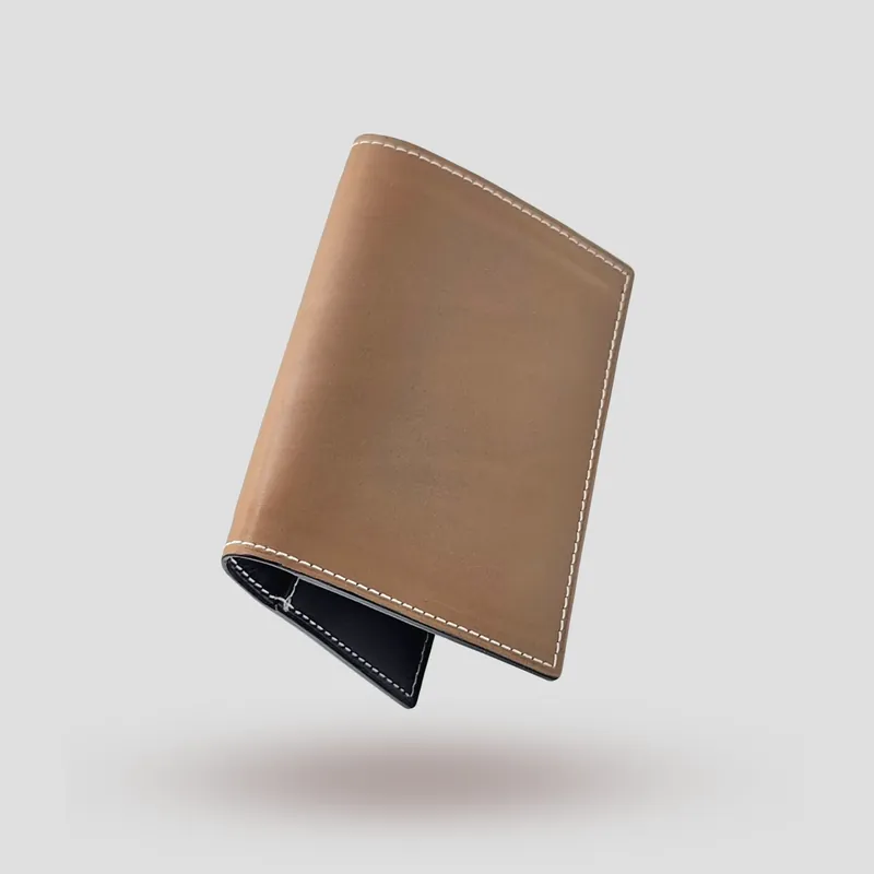 A custom passport cover handcrafted in brown premium cowhide leather with a darker brown goatskin lining.