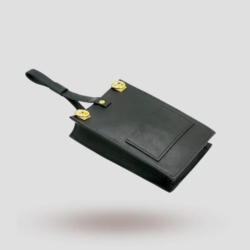 A custom wristlet handcrafted in black premium cowhide leather.