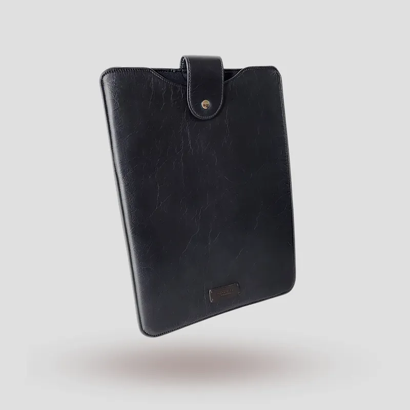 A custom laptop sleeve handcrafted in premium black cowhide leather.