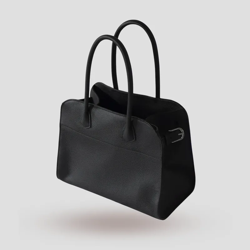 A custom bag handcrafted in black premium Taurillon leather with a deep red French goatskin lining.