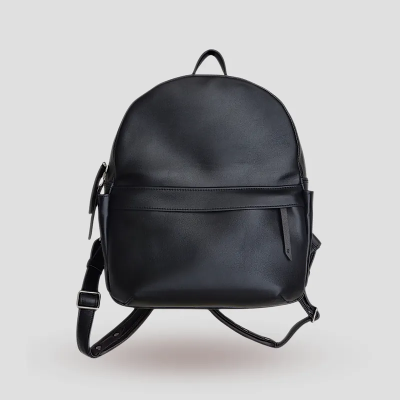 A custom backpack handcrafted in black first-grade Italian calfskin, finished with a French-seam accent and a touch of brown leather.