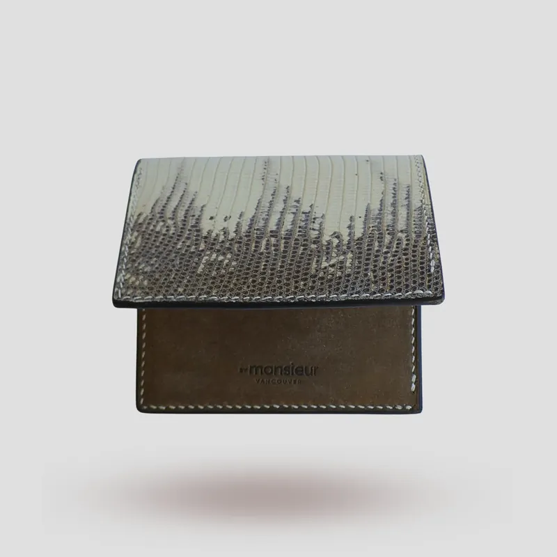 A custom wallet handcrafted in lizard skin with a beige-grey premium Pueblo vegetable-tanned cowhide leather interior.