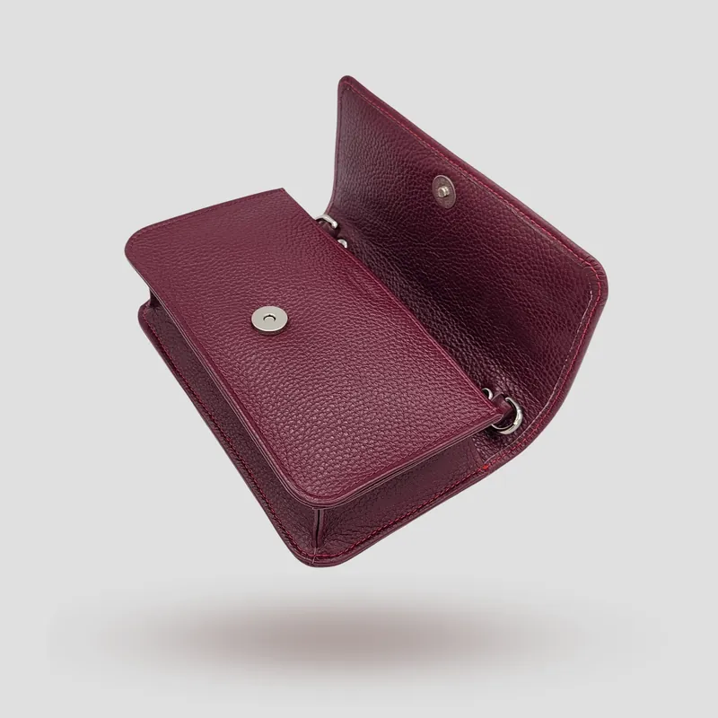 A custom pochette bag handcrafted in burgundy premium cowhide leather.
