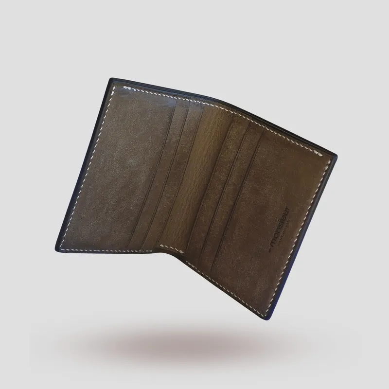 A custom wallet handcrafted in lizard skin with a beige-grey premium Pueblo vegetable-tanned cowhide leather interior.