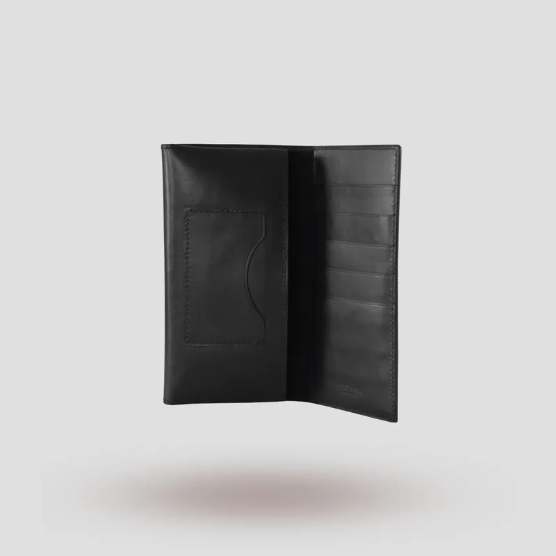 A custom long wallet folio handcrafted in black premium Italian vegetable-tanned cowhide leather with a black suede lining.