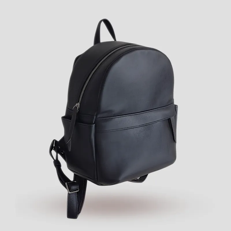 A custom backpack handcrafted in black first-grade Italian calfskin, finished with a French-seam accent and a touch of brown leather.