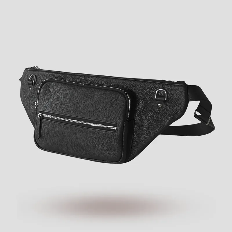 A custom sling bag handcrafted in black premium French shrunken calfskin with a forest green goatskin lining.