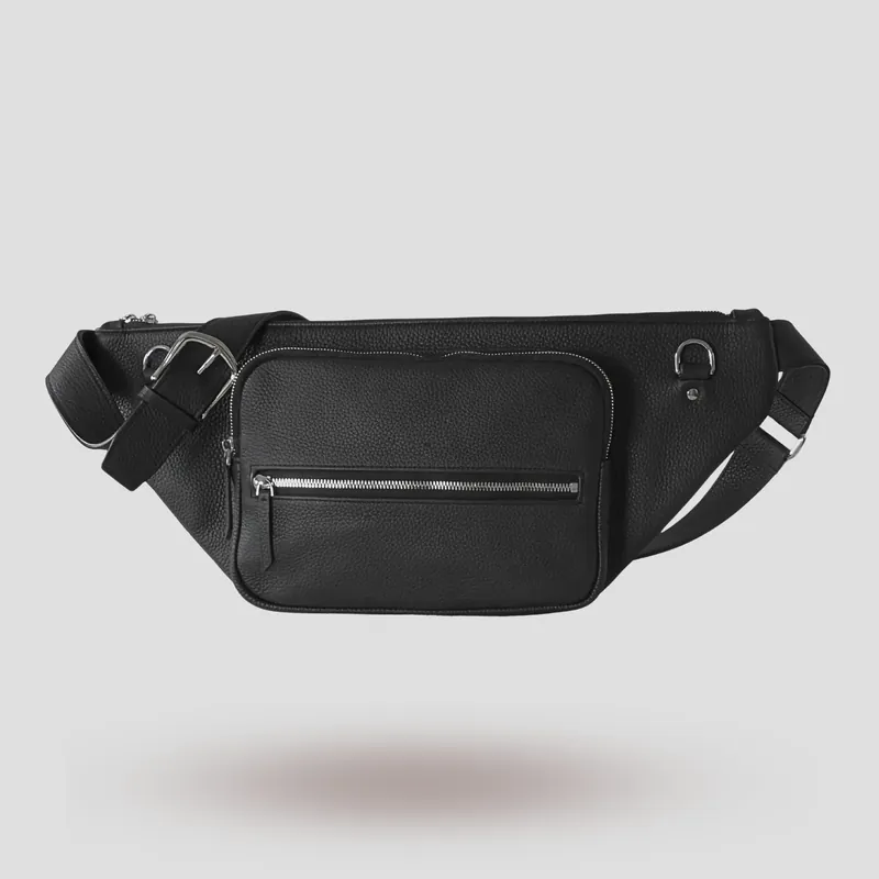 A custom sling bag handcrafted in black premium French shrunken calfskin with a forest green goatskin lining.