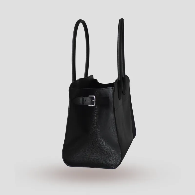 A custom bag handcrafted in black premium Taurillon leather with a deep red French goatskin lining.