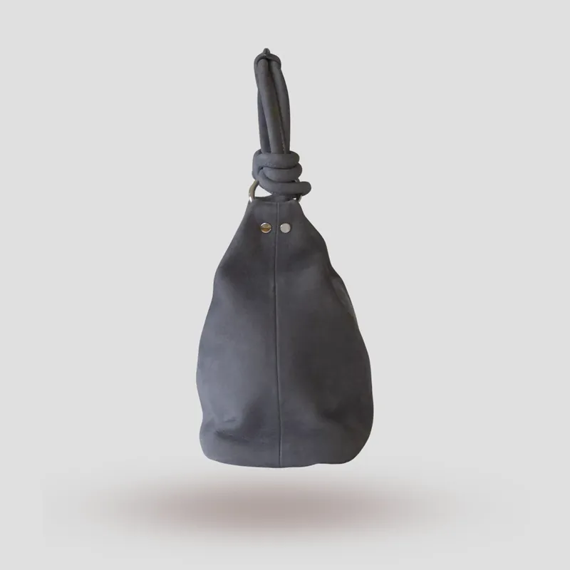 A custom hobo bag handcrafted in toned-down light blue premium nubuck with a light grey lining.