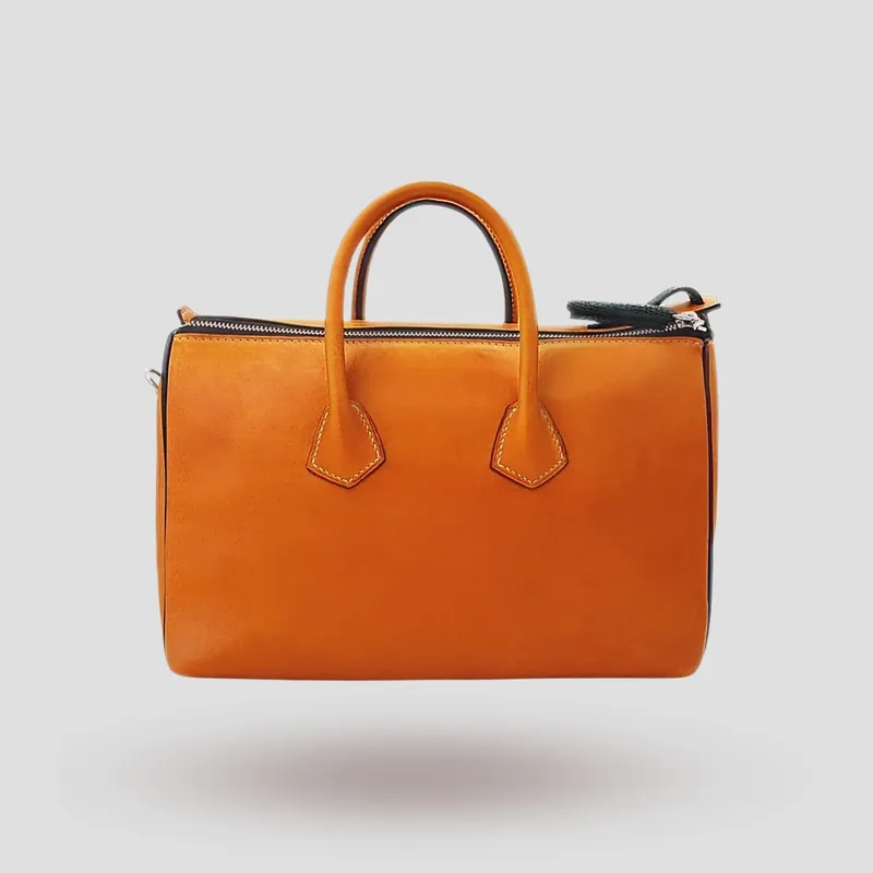 A custom Boston bag handcrafted in mahogany premium horse leather with green lizard skin accents.