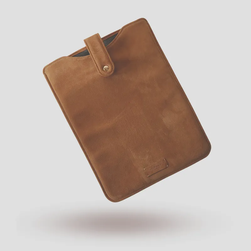A custom laptop sleeve handcrafted in premium beige suede.