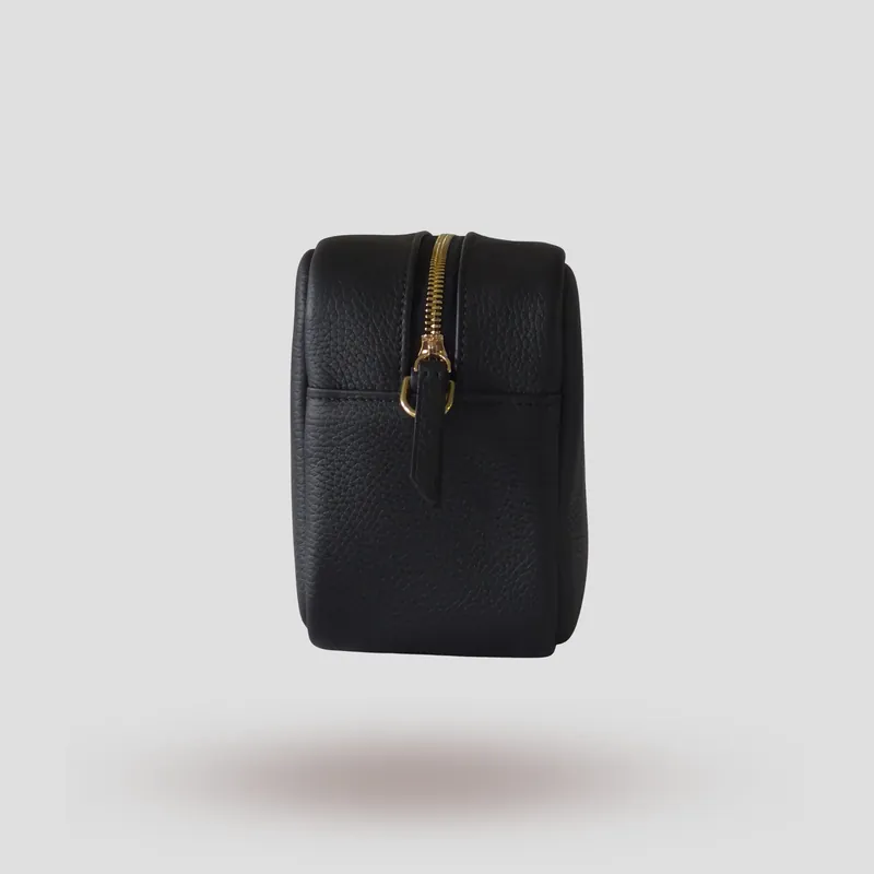 A custom piece handcrafted in black premium Taurillon leather with a teal green goatskin lining.