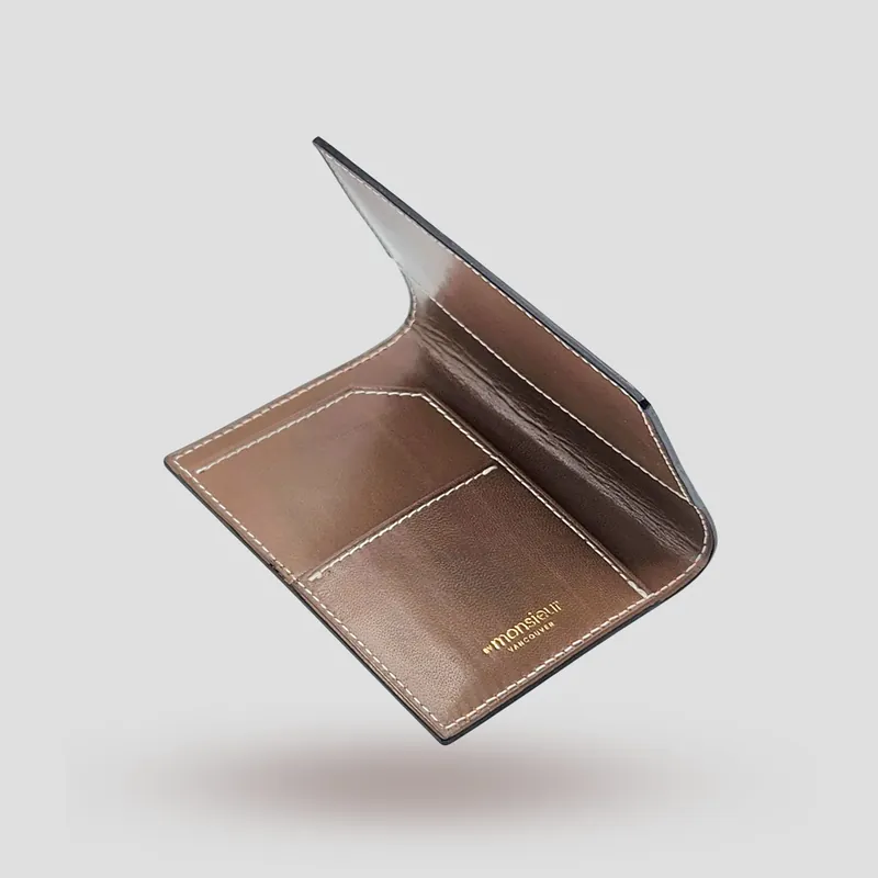 A custom passport cover handcrafted in brown premium cowhide leather with a darker brown goatskin lining.