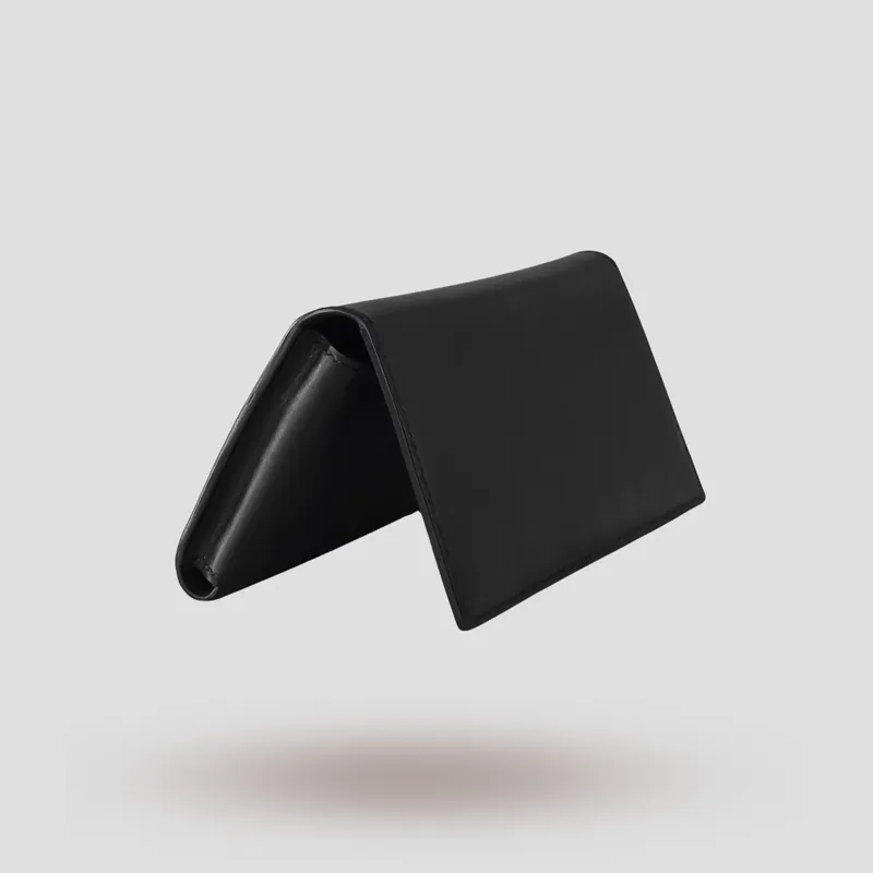 A custom long wallet folio handcrafted in black premium Italian vegetable-tanned cowhide leather with a black suede lining.