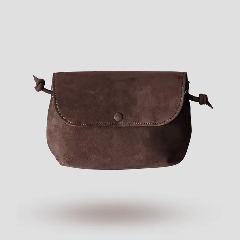 A signature crossbody bag handcrafted in chocolate brown premium suede.