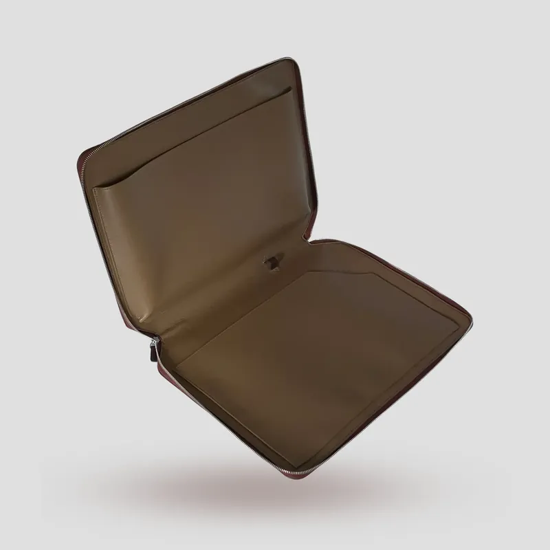 A custom folio handcrafted in chestnut premium cowhide leather with a taupe leather lining.