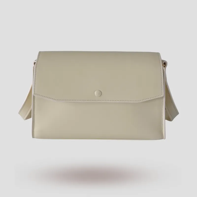 A custom trapezoid bag handcrafted in off-white premium smooth-grain cowhide leather.