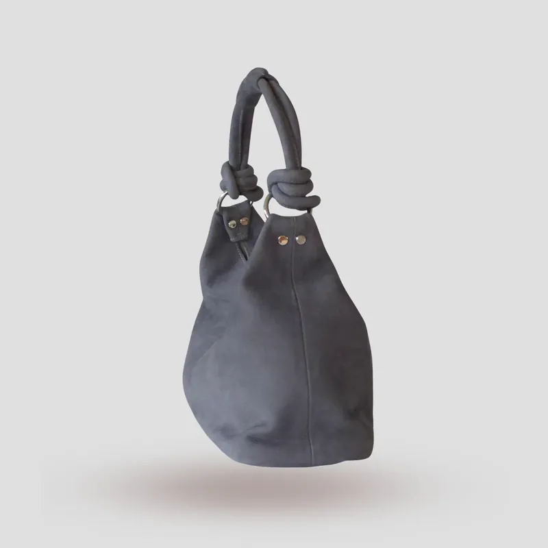 A custom hobo bag handcrafted in toned-down light blue premium nubuck with a light grey lining.