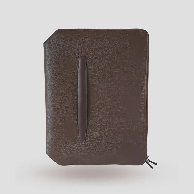 A custom folio handcrafted in chestnut premium cowhide leather with a taupe leather lining.