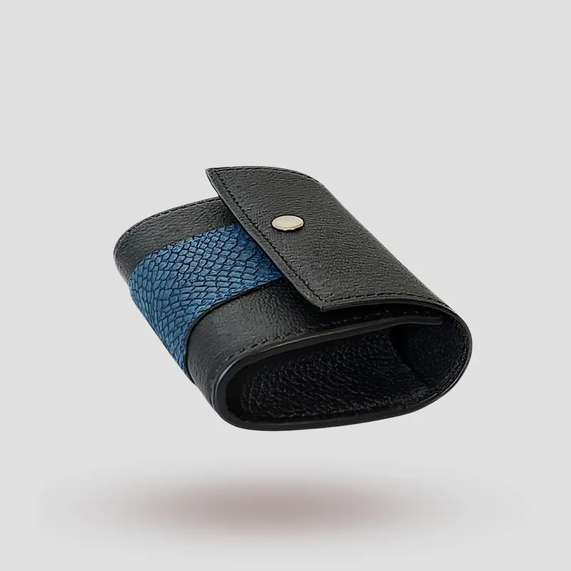 A custom wallet handcrafted in black premium cowhide leather, featuring a bold, asymmetrical wrap accent in salmon leather, paired with a supple goatskin lining.
