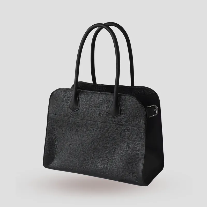 A custom bag handcrafted in black premium Taurillon leather with a deep red French goatskin lining.