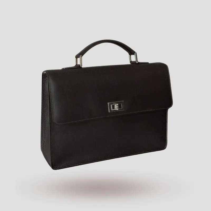 A custom briefcase handcrafted in dark-chocolate premium cowhide leather with an off-white goatskin lining.