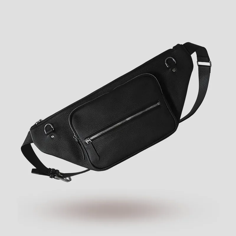 A custom sling bag handcrafted in black premium French shrunken calfskin with a forest green goatskin lining.