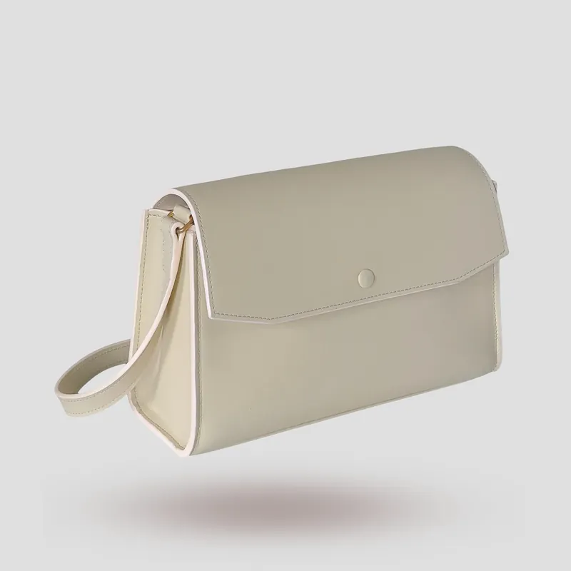 A custom trapezoid bag handcrafted in off-white premium smooth-grain cowhide leather.