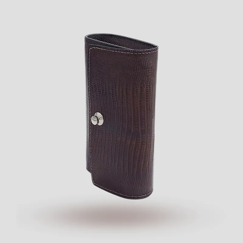 A custom clutch handcrafted in brown lizard leather with a black premium cowhide lining.