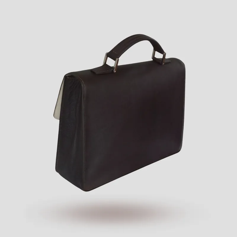 A custom briefcase handcrafted in dark-chocolate premium cowhide leather with an off-white goatskin lining.