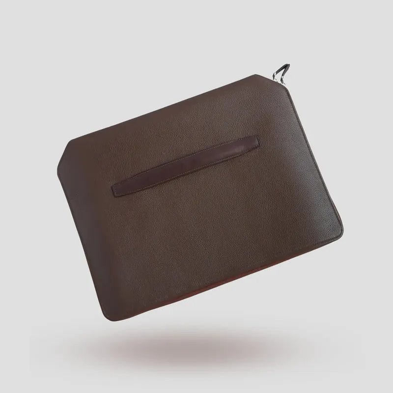 A custom folio handcrafted in chestnut premium cowhide leather with a taupe leather lining.