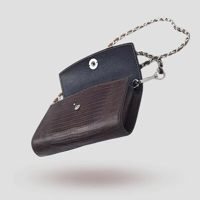 A custom clutch handcrafted in brown lizard leather with a black premium cowhide lining.