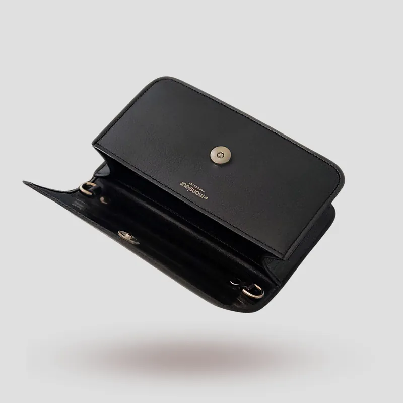 A custom pochette bag handcrafted in black premium cowhide leather.