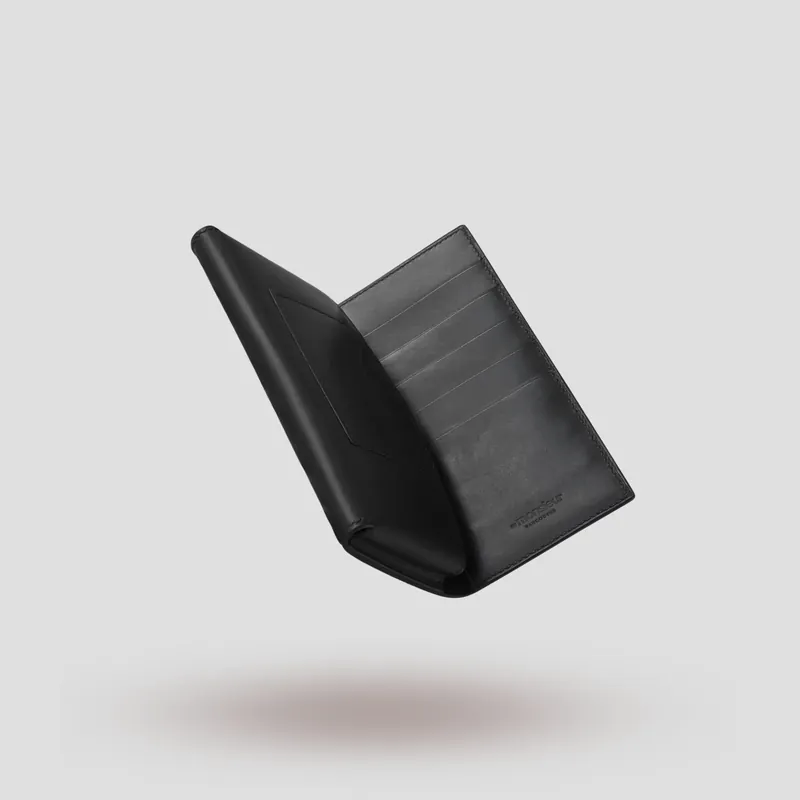 A custom long wallet folio handcrafted in black premium Italian vegetable-tanned cowhide leather with a black suede lining.