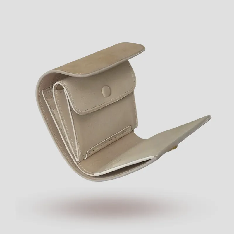 A custom wallet handcrafted in sandy beige-tone premium nubuck with a soft off-white lining tinged with subtle grey.