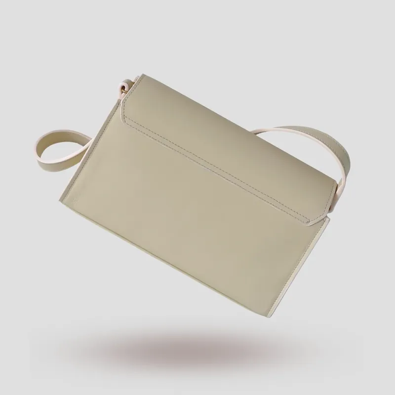 A custom trapezoid bag handcrafted in off-white premium smooth-grain cowhide leather.