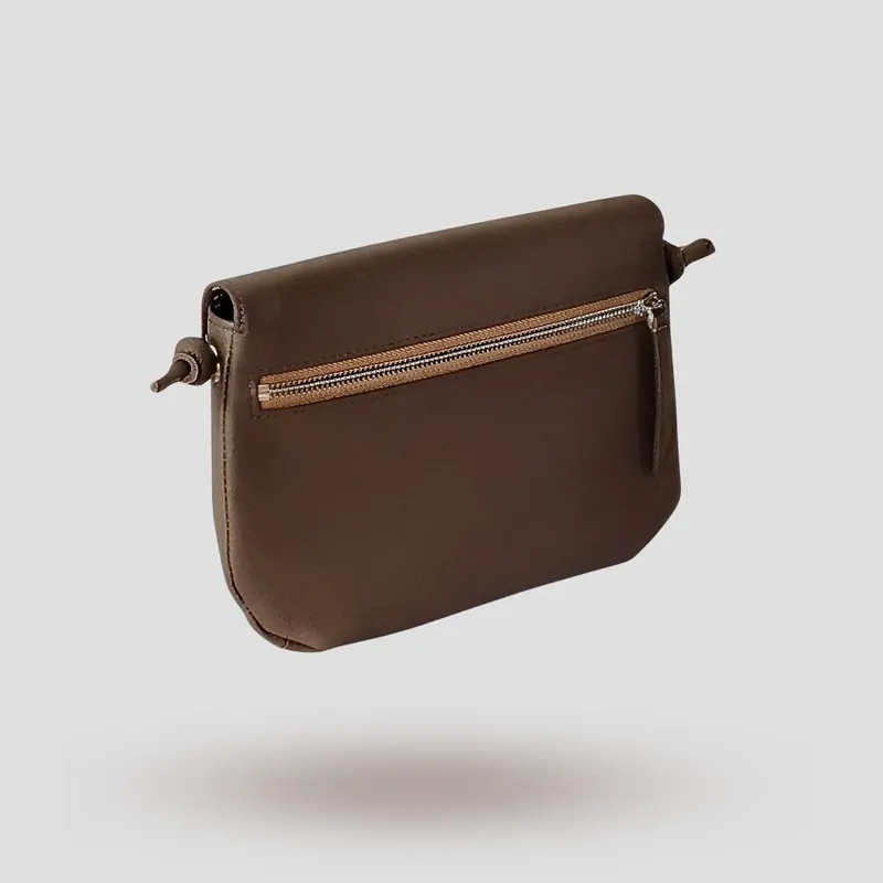 A signature crossbody bag handcrafted in brown premium cowhide leather.