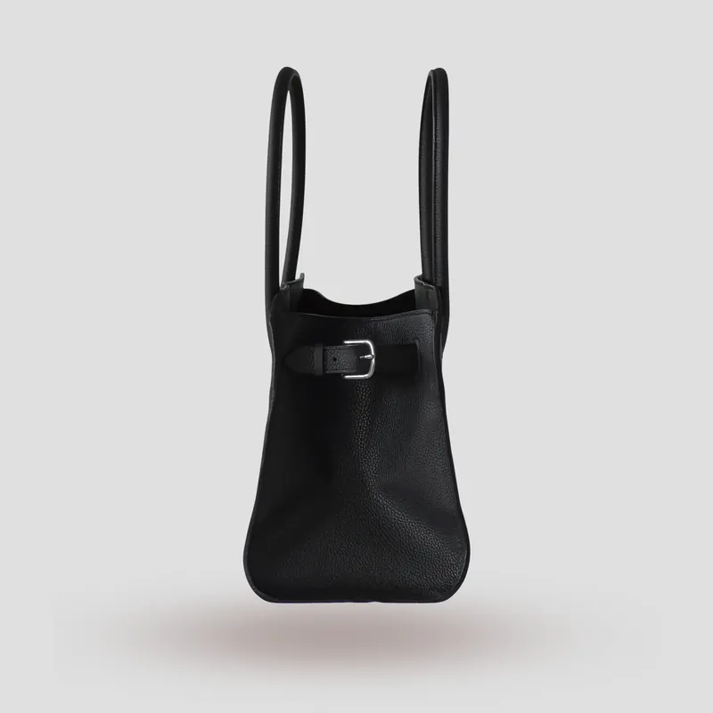 A custom bag handcrafted in black premium Taurillon leather with a deep red French goatskin lining.