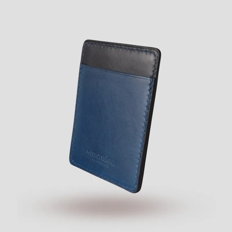 A custom cardholder handcrafted in marine blue and black premium vegetable-tanned leather.
