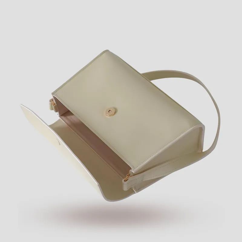 A custom trapezoid bag handcrafted in off-white premium smooth-grain cowhide leather.