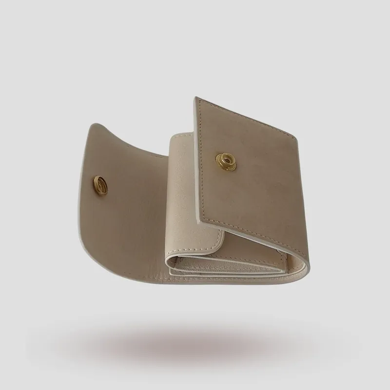 A custom wallet handcrafted in sandy beige-tone premium nubuck with a soft off-white lining tinged with subtle grey.