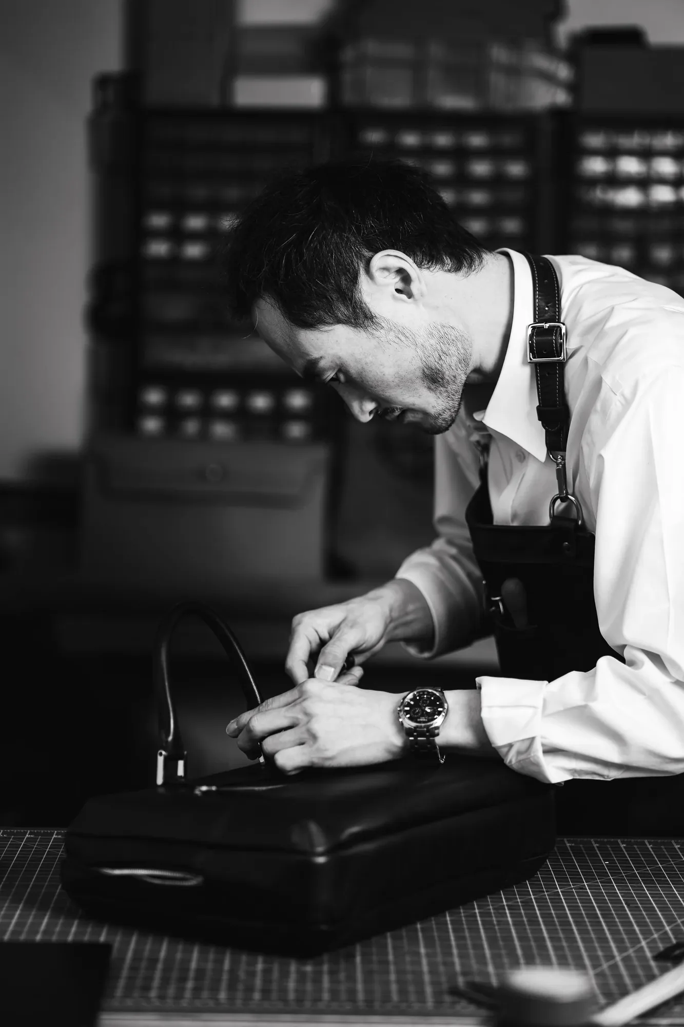 Joe working on a leather briefcase in his atelier.