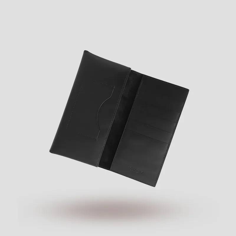 A custom long wallet folio handcrafted in black premium Italian vegetable-tanned cowhide leather with a black suede lining.
