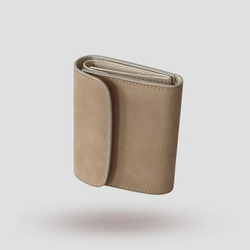 A custom wallet handcrafted in sandy beige-tone premium nubuck with a soft off-white lining tinged with subtle grey.