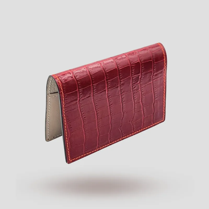 A custom passport cover handcrafted in red premium cowhide leather with an off-white goatskin lining.