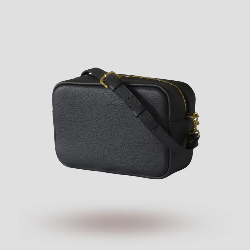 A custom piece handcrafted in black premium Taurillon leather with a teal green goatskin lining.