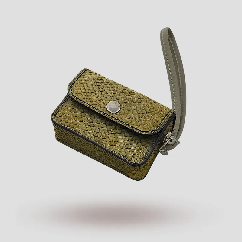 A custom AirPod case handcrafted in olive green premium salmon skin leather.