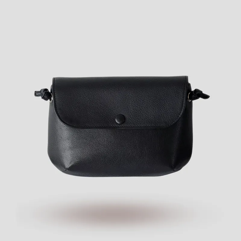 A signature crossbody bag handcrafted in black premium cowhide leather.