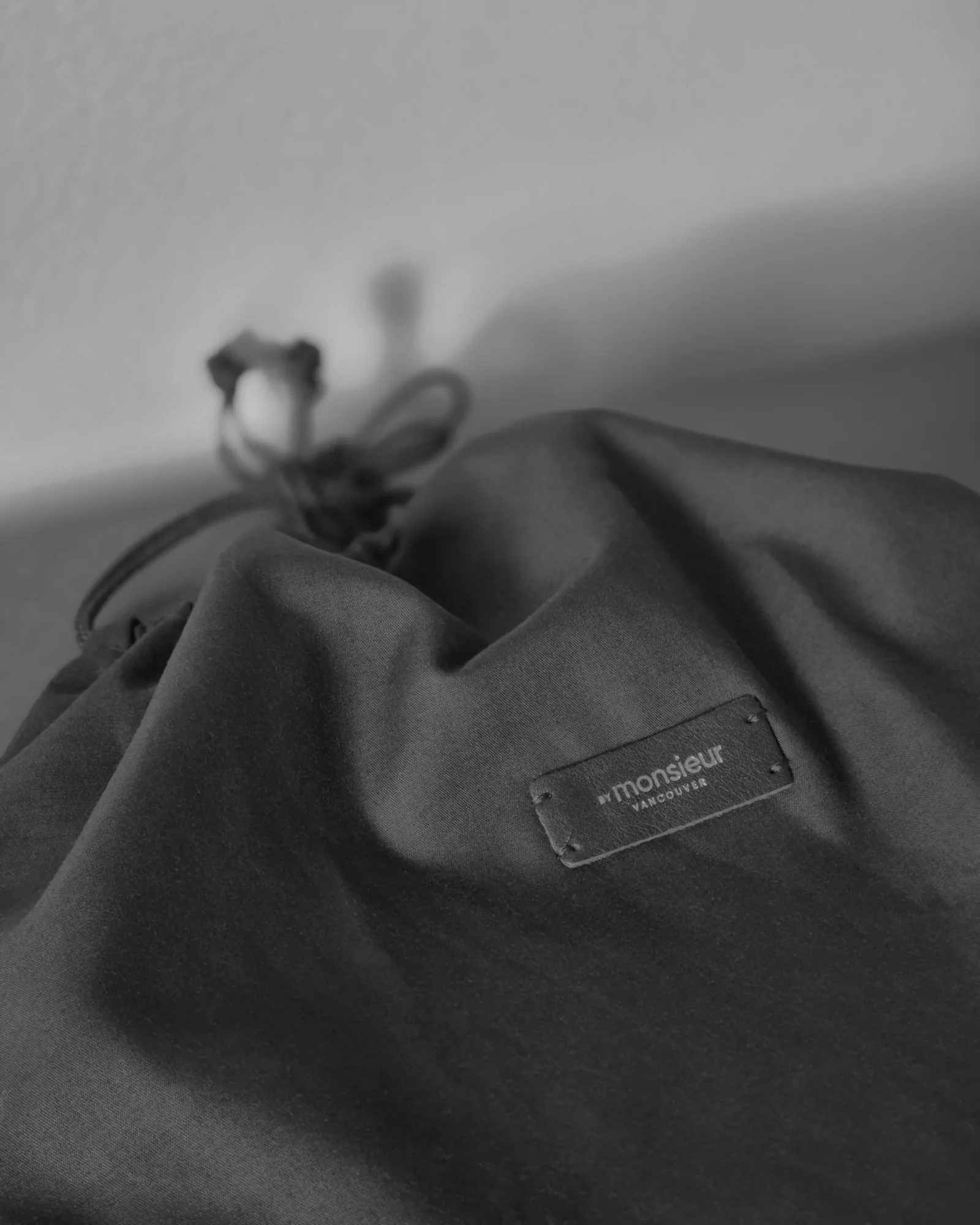 A signature dust bag with BY MONSIEUR's logo